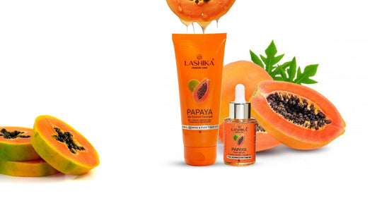 A papaya facewash and papaya serum surrounded by slices of papaya
