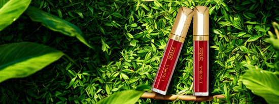 Two tubes of Lashika Vegan Liquid Sindoor placed on lush green leaves. The text reads “Enhance Your Traditional Look with LASHIKA VEGAN SINDOOR” with a “Shop Now” button, emphasizing the product's clean, natural, and tradition-inspired appeal.