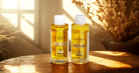Lashika Scalp Therapy Hair Oil and Hair Serum bottles placed on a wooden surface in warm, natural sunlight, with dried floral decor in the background creating a soft, earthy ambiance.