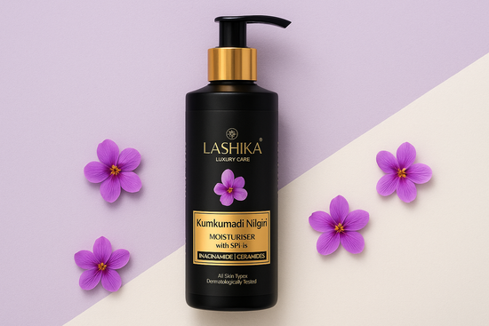 Black bottle of Lashika Luxury Care Kumkumadi Nilgiri Moisturiser with SPF 15 shown on a soft lavender and cream background. The bottle has a gold pump and gold label accents, and is surrounded by small purple flowers for an elegant and soothing aesthetic