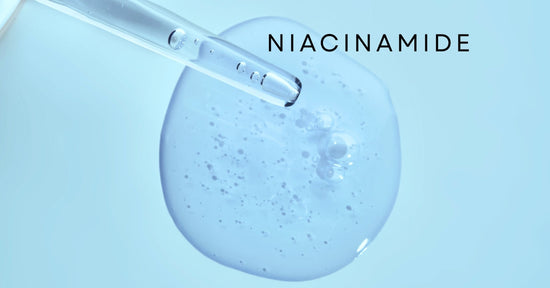 Clear niacinamide serum drops falling highlighting smooth, hydrating skincare texture against a light blue background
