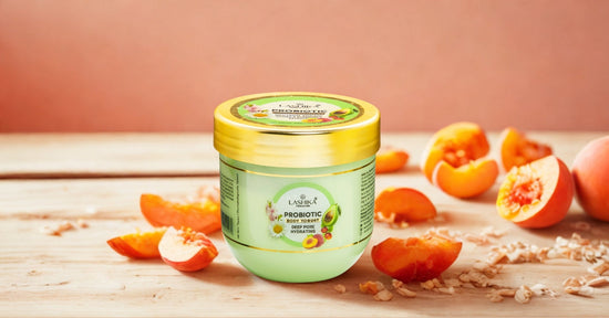 Lashika Probiotic Body Yogurt with Deep Pore Hydrating formula in a green jar with a golden lid, placed on a wooden surface with fresh peaches and a soft pink background.