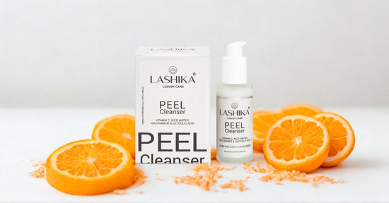 Lashika Peel Cleanser bottle and packaging placed beside fresh orange slices, showcasing key ingredients like Vitamin C, Niacinamide, Rice Water, and Glycolic Acid for glowing, even-toned skin.