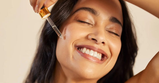A Woman using a glass dropper and applying serum on her face, reflecting purity and skincare.